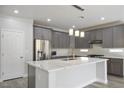 A large kitchen island with pendant lighting and stainless steel appliances is a focal point at 4119 Amberdale Ave, North Las Vegas, NV 89031