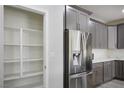 Open white pantry with four shelves for ample storage at 4119 Amberdale Ave, North Las Vegas, NV 89031