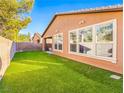 Spacious backyard with artificial turf and a covered patio at 5625 Galivan Vista St, North Las Vegas, NV 89081