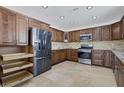 Modern kitchen features stainless steel appliances, granite countertops, tile backsplash, and custom cabinets at 7220 Stormson Dr, Las Vegas, NV 89145
