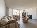 Comfortable living room with large sliding doors to balcony and tile floors at 725 N Royal Crest Cir # 215, Las Vegas, NV 89169