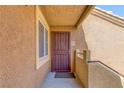 Welcoming condo entrance featuring secure metal door, neutral paint, and unit number 2056 at 7950 W Flamingo Rd # 2056, Las Vegas, NV 89147