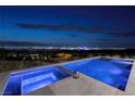 Luxury pool and spa showcasing serene city views with elegant stone and modern design at 1 Boulderback Dr, Henderson, NV 89012