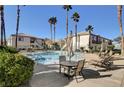 Relaxing pool area with patio furniture and palm trees at 5100 Jordan Frey St # 203, Las Vegas, NV 89130