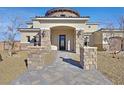 Inviting front entrance with stone pillars, a brick walkway, and elegant outdoor lighting at 5790 Aspen Falls Cir, Las Vegas, NV 89149