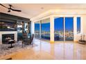 Living room with fireplace, seating area, and access to a balcony with city views at 9101 Alta Dr # 505, Las Vegas, NV 89145