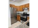 Modern kitchen featuring stainless steel appliances and wood cabinets at 1726 N Jones Blvd, Las Vegas, NV 89108