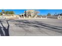 Two-story house behind a gated entrance, seen from across the street at 1964 Westwind Rd, Las Vegas, NV 89146