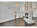 Open living room with dark hardwood floors and a large fireplace at 2114 Inverness Dr, Henderson, NV 89074