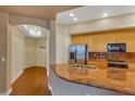 Kitchen with granite countertops, stainless steel appliances, and hardwood floors at 26 E Serene Ave # 124, Las Vegas, NV 89123