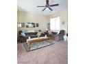 Bright living room with ceiling fan, with beach-themed decor creating a serene and inviting ambiance at 4625 Centisimo Dr # 202, North Las Vegas, NV 89084