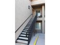 Exterior view of a modern staircase with metal railings leading to a second-floor entrance at 4625 Centisimo Dr # 202, North Las Vegas, NV 89084