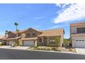 Two-story house with tan exterior, tile roof, and attached garage at 5000 Forest Oaks Dr, Las Vegas, NV 89149