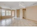 Open living space with tile flooring, ceiling fan, neutral paint and modern light fixture at 5201 Progresso St, Las Vegas, NV 89135