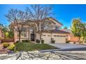 Two-story house with a two-car garage and lush green lawn at 5423 San Florentine Ave, Las Vegas, NV 89141