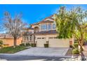 Beige two-story house with a three-car garage and mature trees at 5423 San Florentine Ave, Las Vegas, NV 89141