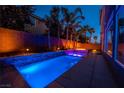 Night view of a backyard pool and spa with lighting at 5956 Lambert Bridge Ave, Las Vegas, NV 89139