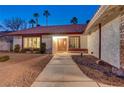 House entrance with a wooden door and pathway at 6466 Scotch Pine Cir, Las Vegas, NV 89146