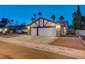 Two-car garage with white doors and brick exterior at 6466 Scotch Pine Cir, Las Vegas, NV 89146