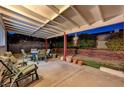 Covered patio with seating area and potted plants at 6466 Scotch Pine Cir, Las Vegas, NV 89146
