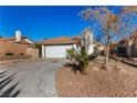 Front view of a single story home with a white garage door at 7748 Selby Ct, Las Vegas, NV 89147