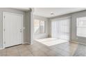 Light-filled entrance with tile floor, white door, and window at 881 Blushing Rose Pl, Henderson, NV 89052