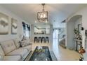 Open living area with light flooring, fireplace and kitchen view at 9100 Spoonbill Ridge Pl, Las Vegas, NV 89143