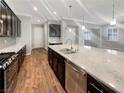Modern kitchen with island, stainless steel appliances, and hardwood floors at 480 Sterling Falls Ave, Henderson, NV 89011