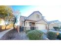 Two-story house with stone accents, attached garage, and landscaping at 59 Dreamy Hill Ave, North Las Vegas, NV 89031