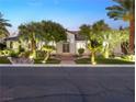 Stunning curb appeal with lush landscaping and lighting at 7840 Thunder Echo St, Las Vegas, NV 89131