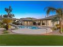 Inviting pool area with a water slide and artificial turf at 7840 Thunder Echo St, Las Vegas, NV 89131