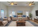Virtually staged living room with beige sofas and wooden coffee table at 799 Bluebird Dr, Boulder City, NV 89005