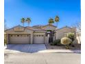 Beautiful home with three-car garage and desert landscaping at 869 Ashford Way, Henderson, NV 89015