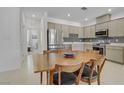 Bright modern kitchen featuring stainless steel appliances and adjacent dining area at 1103 Tektite Ave, Henderson, NV 89011