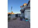 Front yard view of two-story house with block wall and gate at 3338 Commendation Dr, Las Vegas, NV 89117