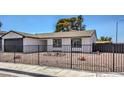 House exterior with a black metal fence and rock landscaping at 4111 E Saint Louis Ave, Las Vegas, NV 89104