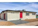 Single story home with red door and gray stone driveway at 5100 Kansas Ave, Las Vegas, NV 89107