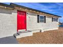 Close up view of front door and portion of house exterior at 5100 Kansas Ave, Las Vegas, NV 89107