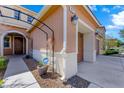View showcases home's entrance, walkway, and attached two-car garage at 917 Old Creek Way, North Las Vegas, NV 89084