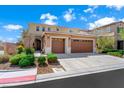 Exterior view of charming two-story home with well-maintained landscaping and three car garage at 917 Old Creek Way, North Las Vegas, NV 89084