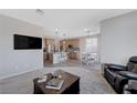 Open living room, kitchen, and dining area with modern finishes at 10122 Ashford Mill Ct, Las Vegas, NV 89178
