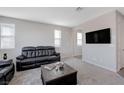 Living room features a black leather couch and a coffee table at 10122 Ashford Mill Ct, Las Vegas, NV 89178