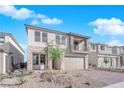Two-story house with balcony, attached garage, and landscaped front yard at 10224 Eden Mountain St, Las Vegas, NV 89141