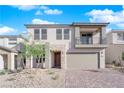 Two-story house with balcony, attached garage, and landscaped front yard at 10224 Eden Mountain St, Las Vegas, NV 89141