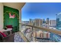 Relaxing balcony seating area featuring great city views and decorative floral wall at 135 E Harmon Ave # 2721, Las Vegas, NV 89109