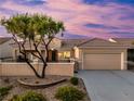 Single-story home with landscaped yard, two-car garage, and attractive facade at 2219 Sawtooth Mountain Dr, Henderson, NV 89044