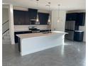 Modern kitchen featuring dark blue cabinetry, a large island, and stainless steel appliances at 2753 Piazza Madama St, Henderson, NV 89044