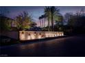Night view of community entrance sign with illuminated fountain and lush greenery at 36 Avenida Fiori, Henderson, NV 89011
