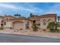 Charming single-story home featuring a desert landscape, tile roof, and inviting curb appeal at 36 Avenida Fiori, Henderson, NV 89011