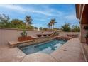 Inviting private pool and spa with stone accents, lush landscaping, and outdoor seating area at 36 Avenida Fiori, Henderson, NV 89011